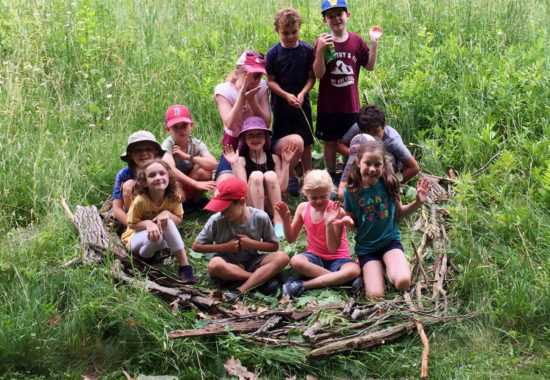 Students in a giant hand-made nest