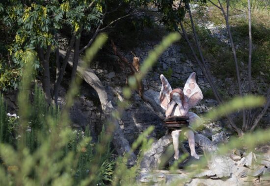 Statue of a fairy with books